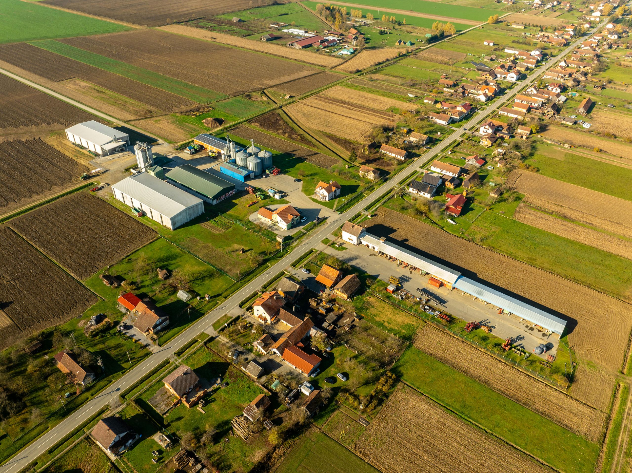 Aerial view of rural landscape in Garešnica, Croatia with farmlands and buildings.